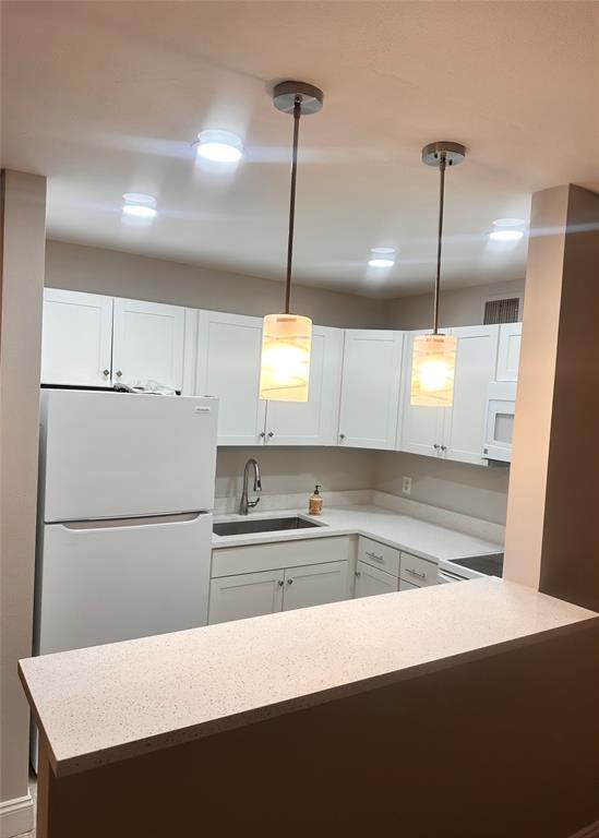 201 Inlet Way Palm Beach Shores, FL 33404 - Photo 5 of 9 a kitchen with a refrigerator a sink and cabinets