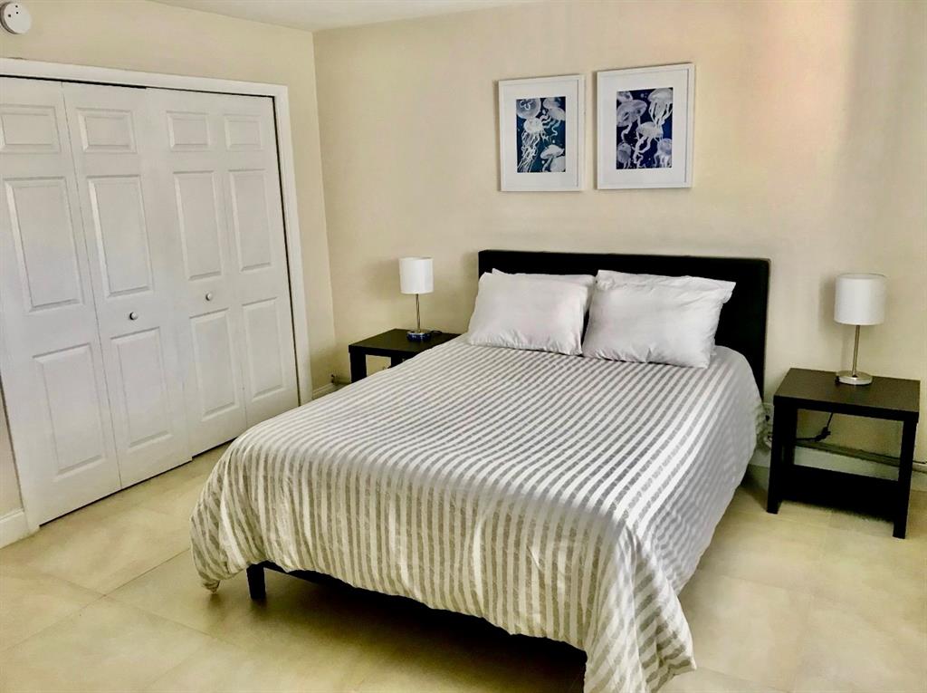 201 Inlet Way Palm Beach Shores, FL 33404 - Photo 8 of 9 a bedroom with a bed and painting on the wall