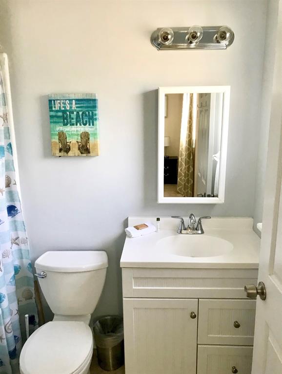 201 Inlet Way Palm Beach Shores, FL 33404 - Photo 9 of 9 a bathroom with a toilet sink and mirror