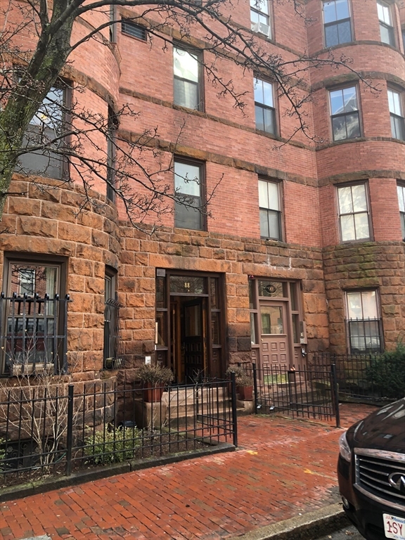 a view of a brick building with many windows