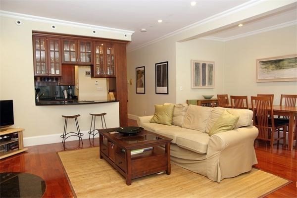 88 St Botolph Street, Unit 3 Boston, MA 02116 - Photo 4 of 11 a living room with furniture and a flat screen tv