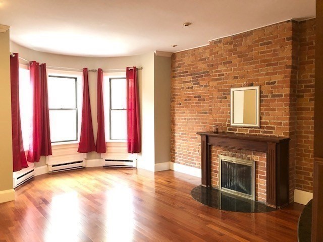 88 St Botolph Street, Unit 3 Boston, MA 02116 - Photo 5 of 11 a view of a living room with a fireplace and floor to ceiling window