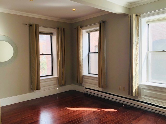 88 St Botolph Street, Unit 3 Boston, MA 02116 - Photo 6 of 11 a view of an empty room with wooden floor and a window