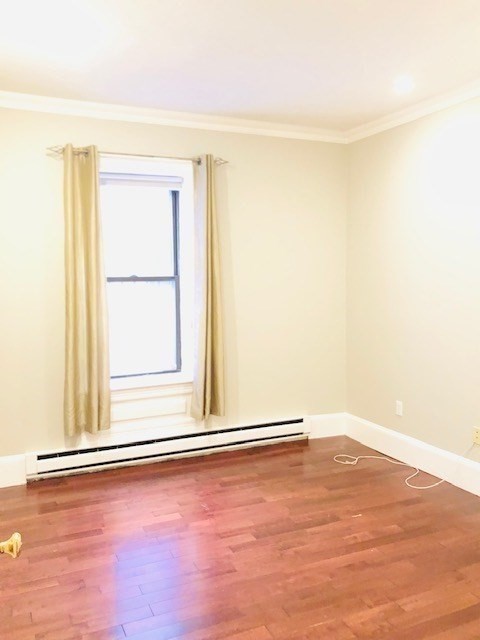 88 St Botolph Street, Unit 3 Boston, MA 02116 - Photo 7 of 11 an empty room with wooden floor and windows