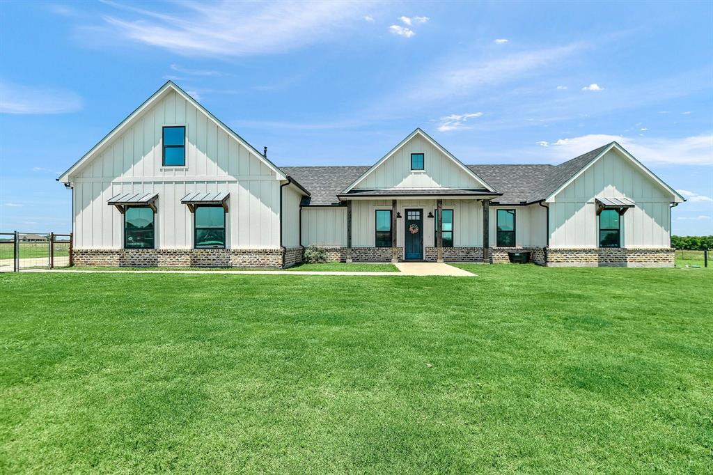 951 Sedalia Road Van Alstyne, TX 75495 - Photo 1 of 1 Modern farmhouse style home with fence, a shingled roof, board and batten siding, a front lawn, and a porch