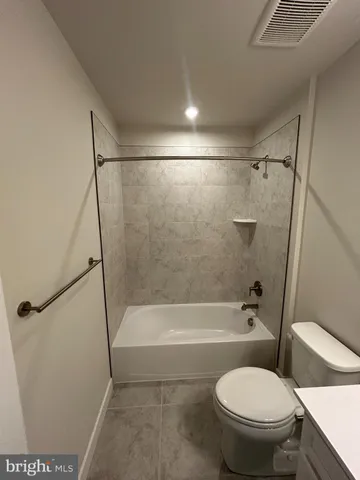 a bathroom with a sink toilet and a mirror
