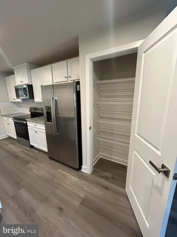 a kitchen with stainless steel appliances a refrigerator and a stove