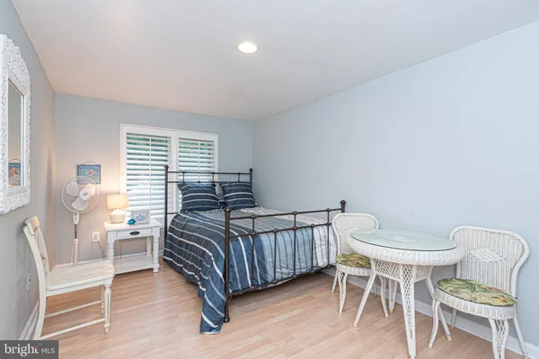 a bedroom with a bed chair and a window