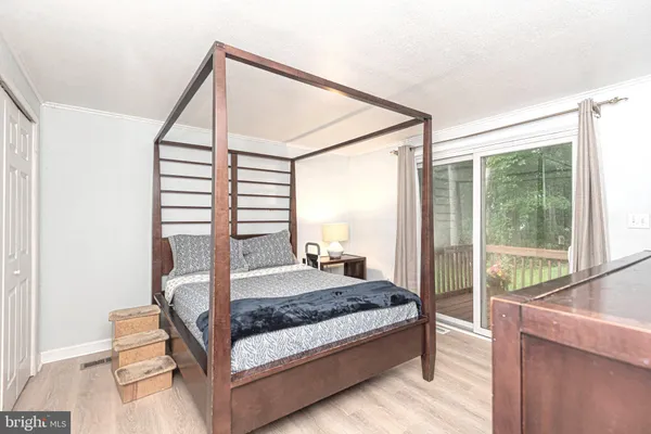 a bedroom with a bed and a large window