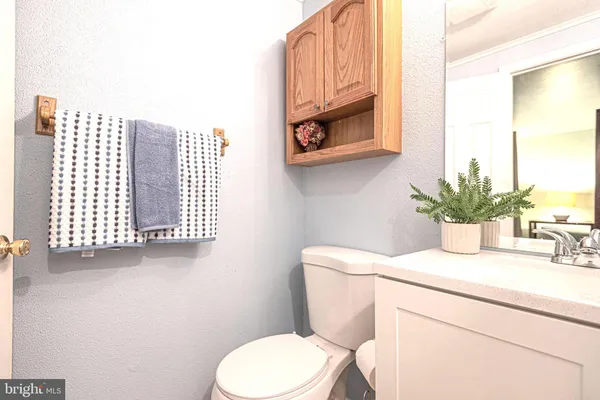 a bathroom with a toilet a sink and a mirror