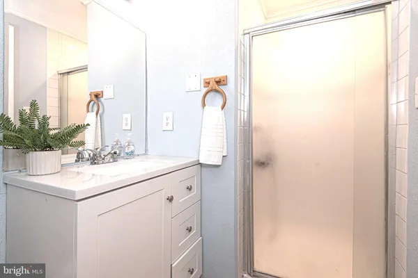 a bathroom with a sink vanity and a mirror