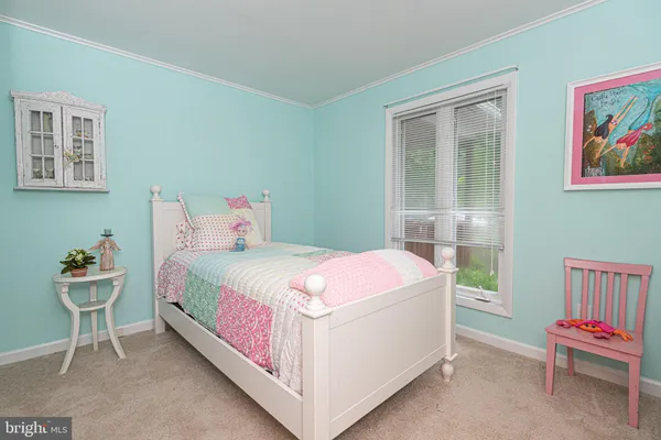 a bedroom with a bed and a chair