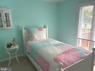 a bedroom with a bed and a chair