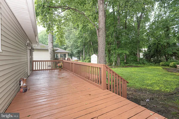 a view of deck with wooden floor and trees