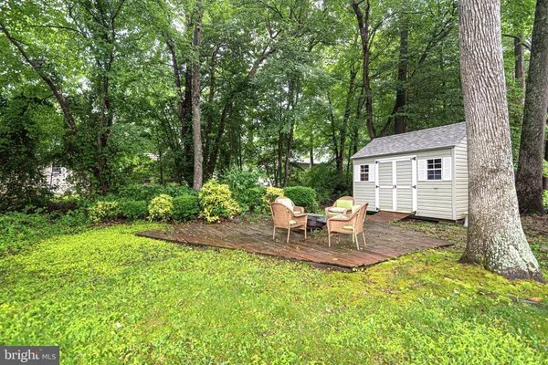 a view of a backyard with chairs and garden