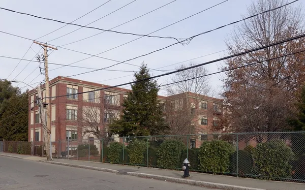 a view of a street with a building in the background