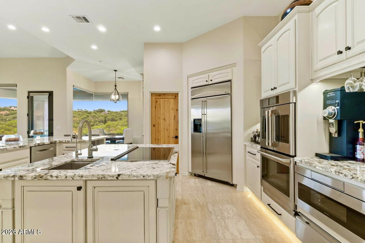 15730 East Eagle Crest Road Fountain Hills, AZ 85268 - Photo 15 of 77 a kitchen with stainless steel appliances kitchen island granite countertop a refrigerator and a sink