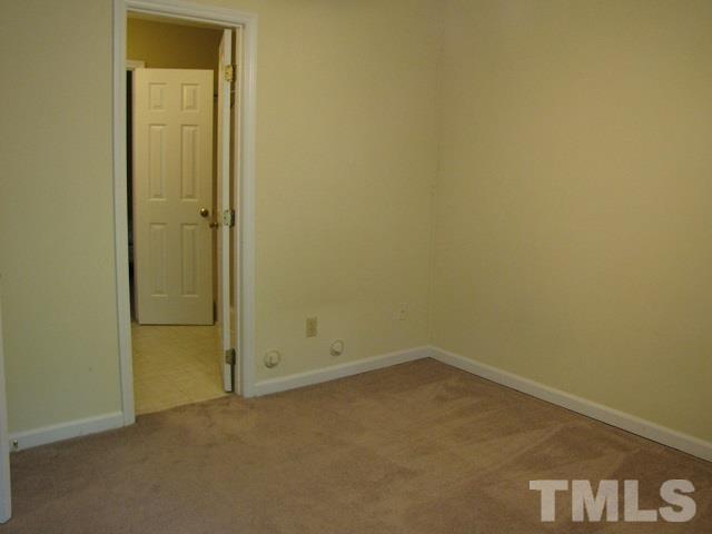 2 Carson Circle, Unit B Durham, NC 27705 - Photo 9 of 15 an empty room with a door