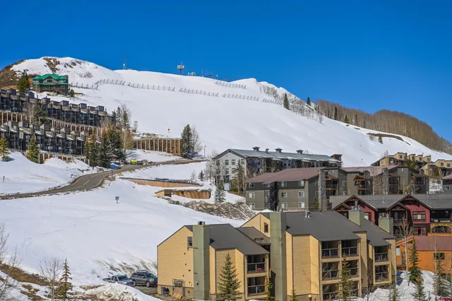 a view of a patio with table and chairs with wooden floor and fence