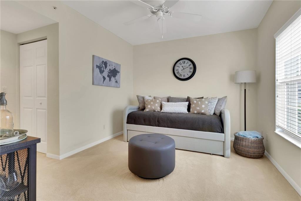 6923 Satinleaf Road North, Unit 101 Naples, FL 34109 - Photo 12 of 50 a bedroom with a bed and a window