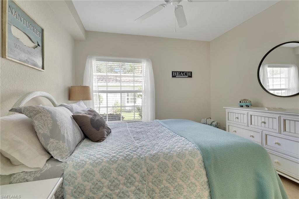 6923 Satinleaf Road North, Unit 101 Naples, FL 34109 - Photo 19 of 50 a bedroom with a bed and a window