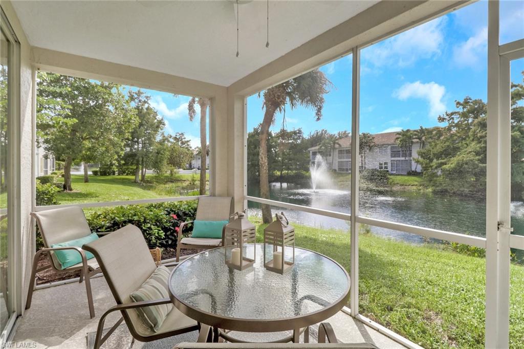 6923 Satinleaf Road North, Unit 101 Naples, FL 34109 - Photo 23 of 50 a dining room with a table chairs and a yard