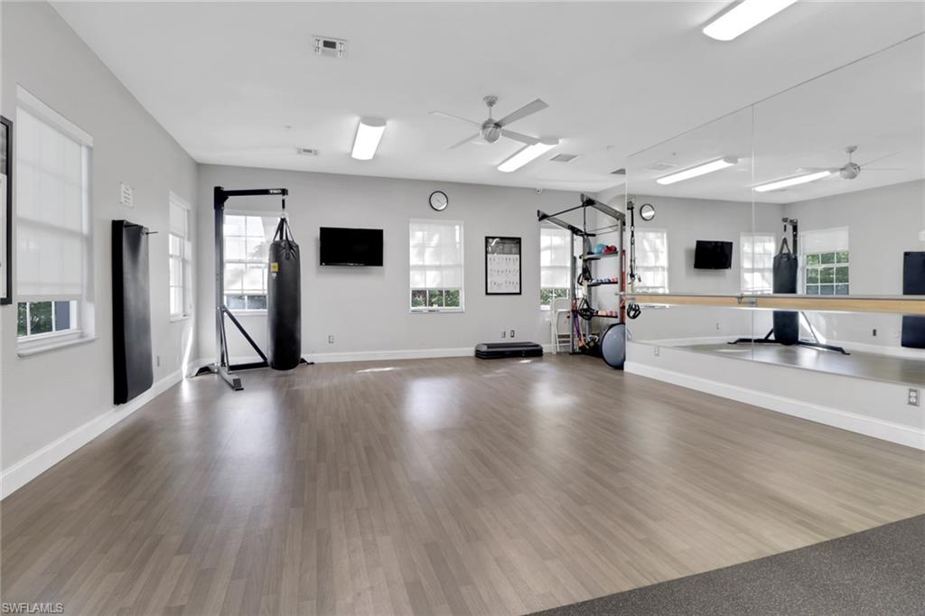 6923 Satinleaf Road North, Unit 101 Naples, FL 34109 - Photo 31 of 50 a view of a living room and a flat screen tv