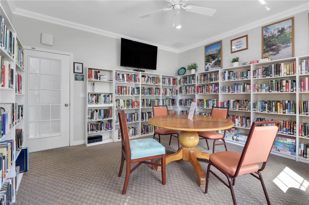 6923 Satinleaf Road North, Unit 101 Naples, FL 34109 - Photo 40 of 50 a view of a livingroom with furniture and a bookshelf