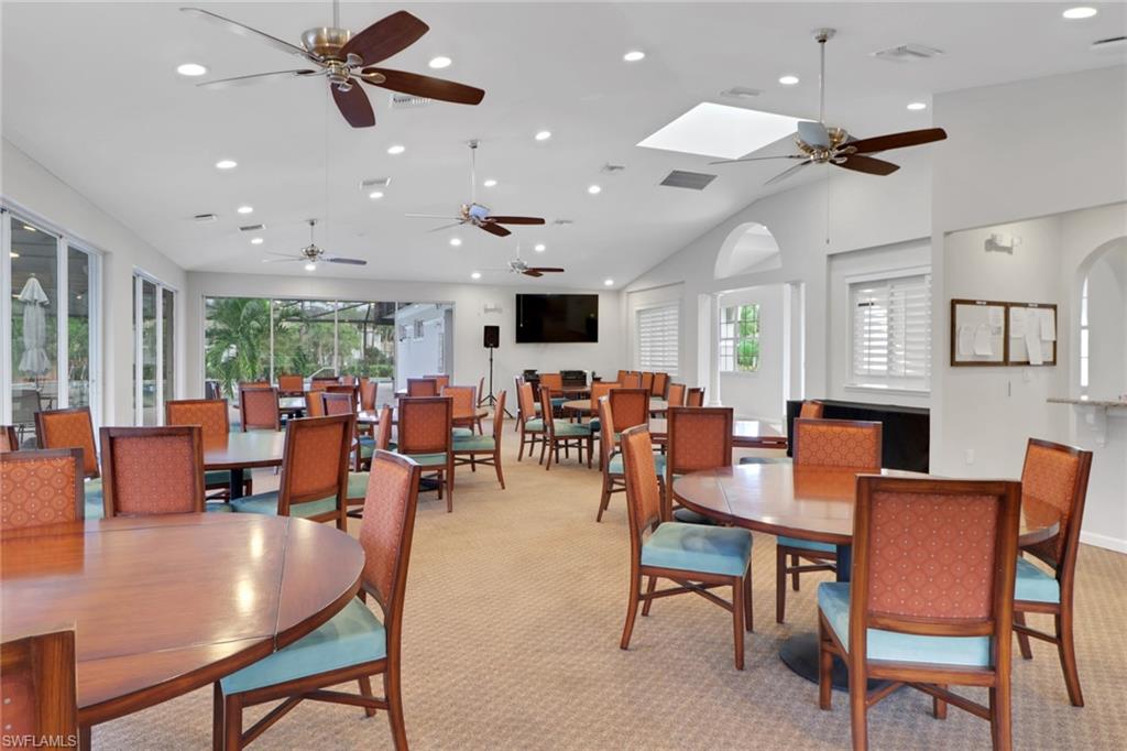 6923 Satinleaf Road North, Unit 101 Naples, FL 34109 - Photo 42 of 50 a living room with lots of furniture and a flat screen tv