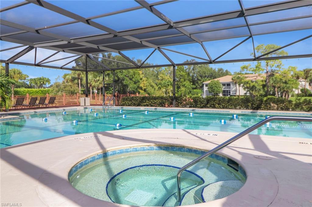6923 Satinleaf Road North, Unit 101 Naples, FL 34109 - Photo 46 of 50 a small view of a swimming pool with a yard