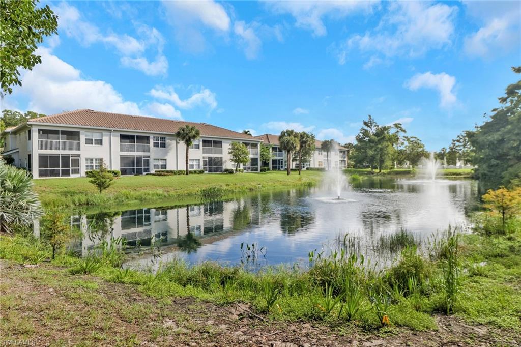 6923 Satinleaf Road North, Unit 101 Naples, FL 34109 - Photo 48 of 50 a view of a lake with a house in the background