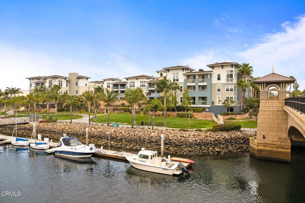 a view of a lake with a cars parked in front of it