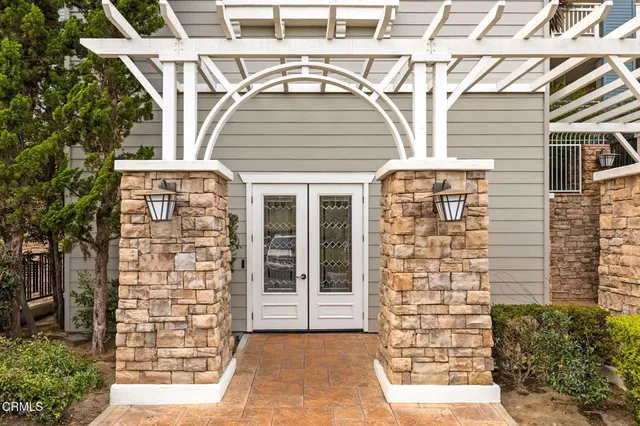 a kitchen with stainless steel appliances granite countertop a stove top oven a sink a counter top space cabinets and a dining table