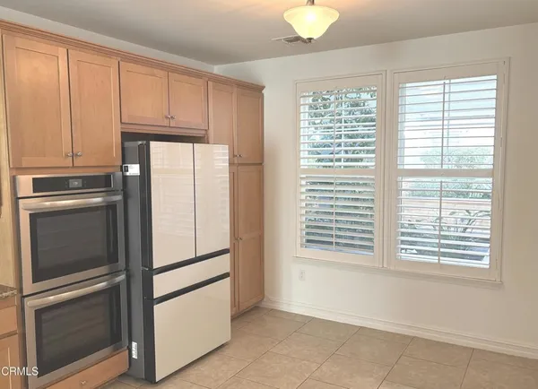 a kitchen with granite countertop cabinets and chairs