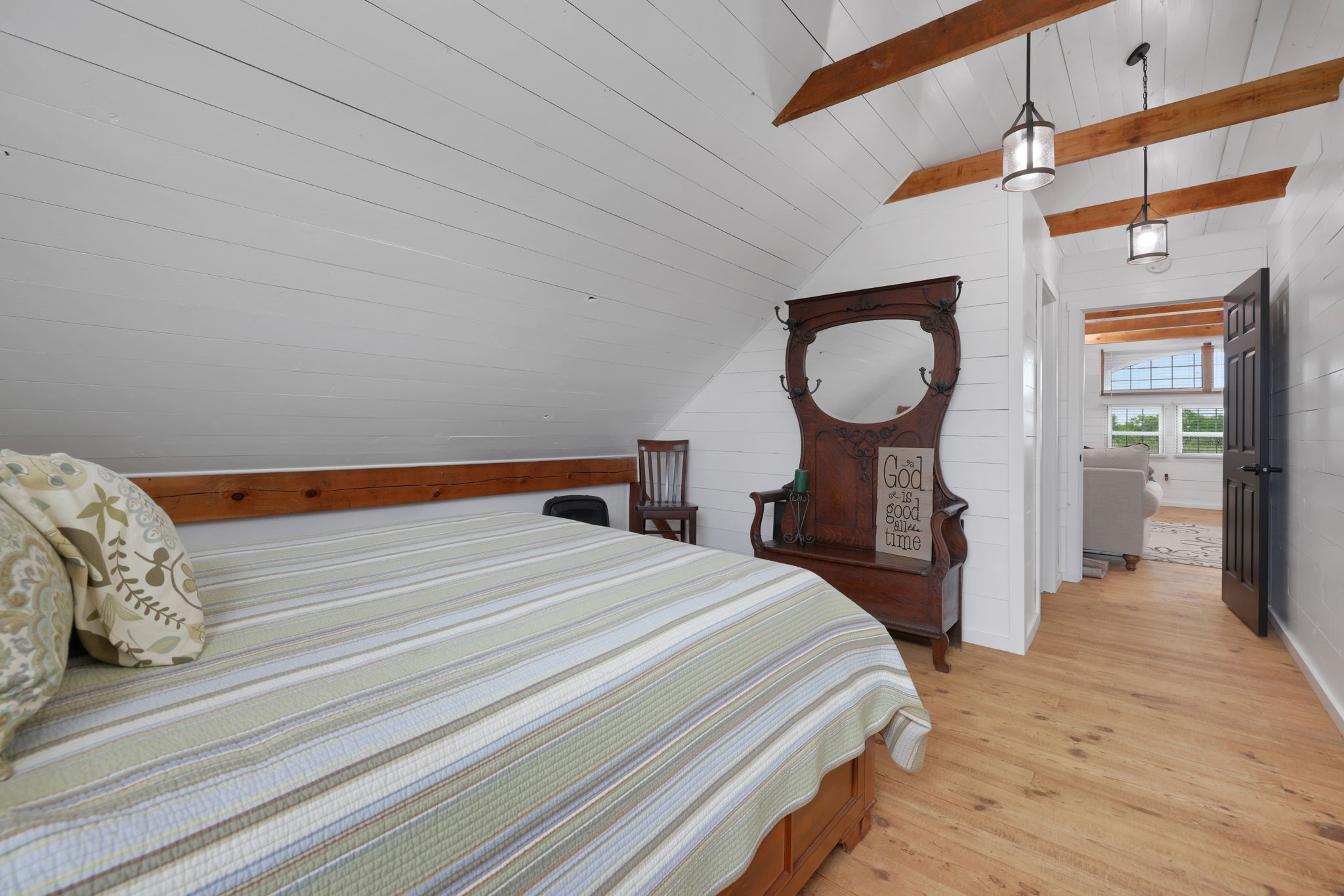 133 Timber Ridge Road Liberty, TX 77575 - Photo 26 of 29 a bedroom with a bed and a chandelier