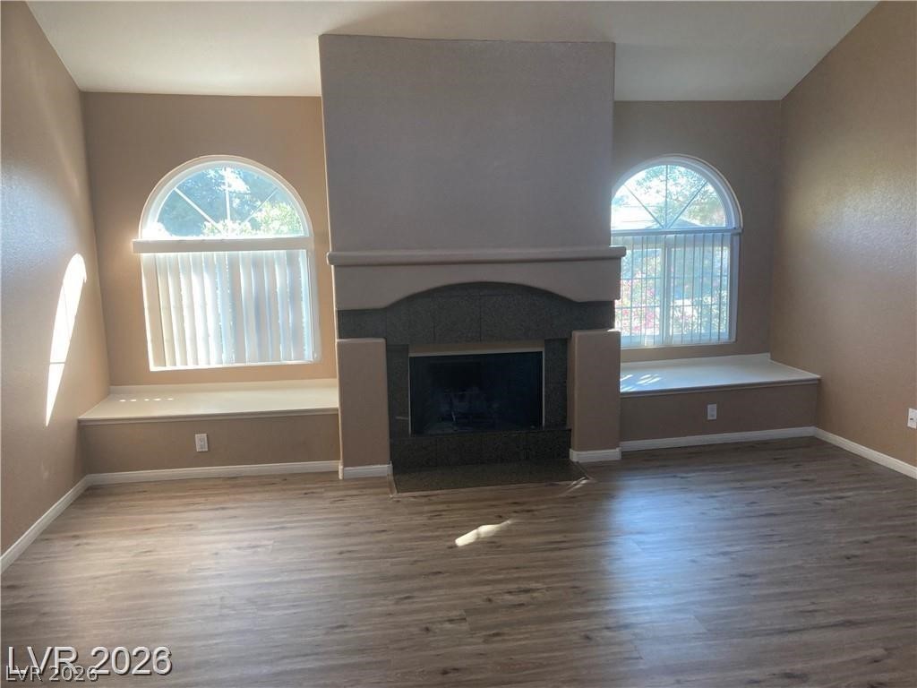 3145 East Flamingo Road, Unit 2100 Las Vegas, NV 89121 - Photo 8 of 34 A welcoming living area boasts a central fireplace, flanked by charming arched windows.