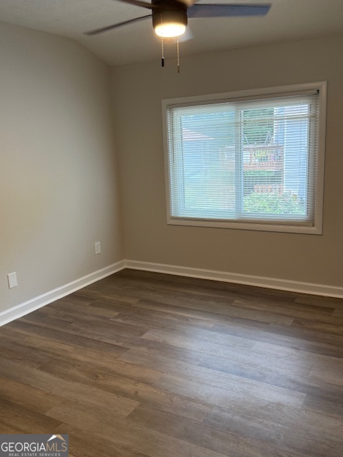 224 Twiggs Corners Peachtree City, GA 30269 - Photo 10 of 28 a view of an empty room with wooden floor and a window