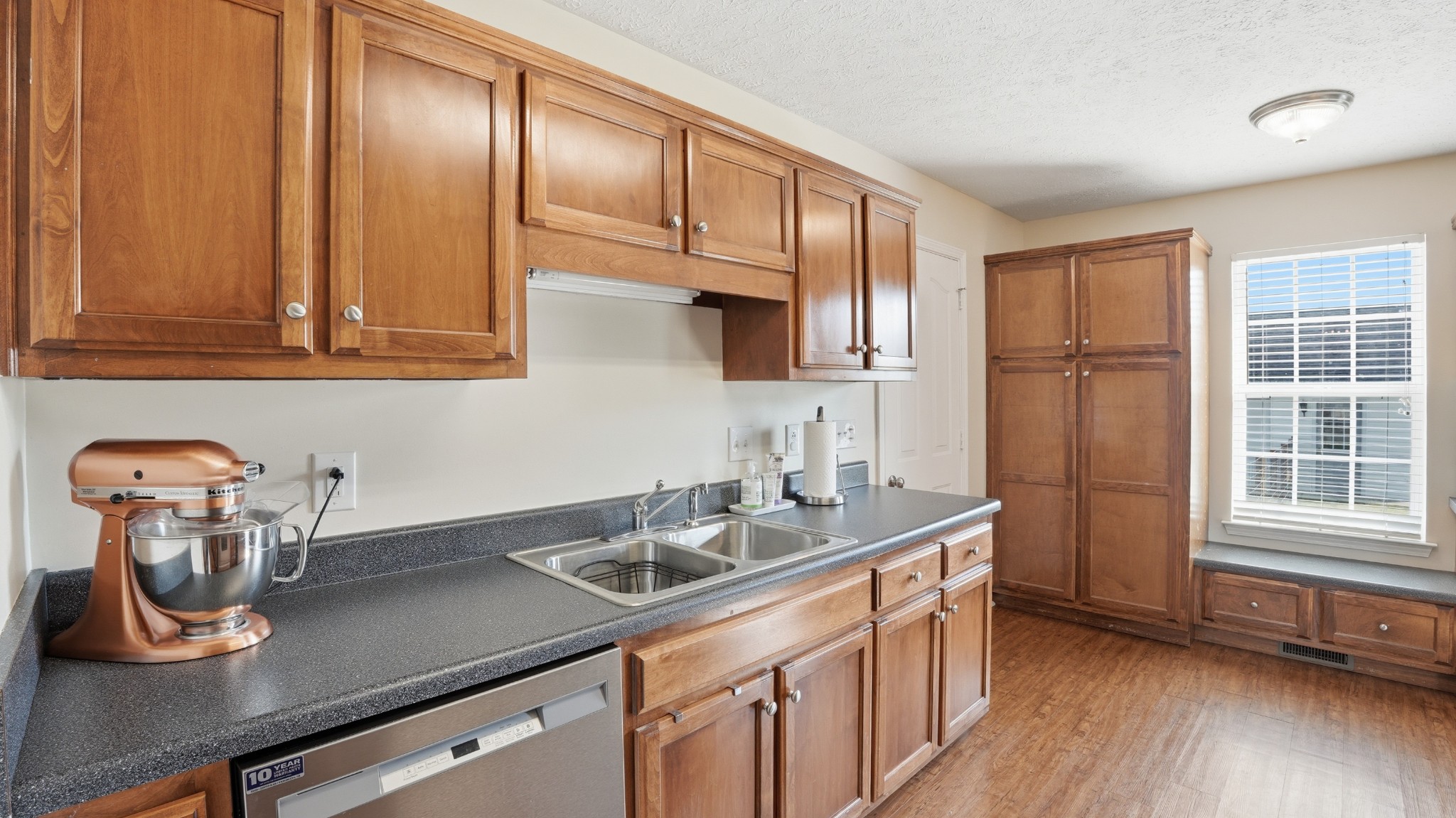 2877 Sixteenth Model Road Manchester, TN 37355 - Photo 23 of 38 a kitchen with stainless steel appliances granite countertop a sink a stove and a wooden cabinets