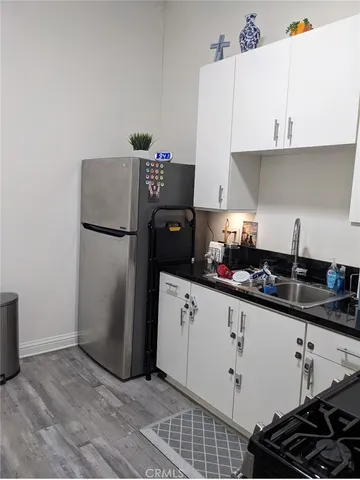 a kitchen with a sink and a refrigerator