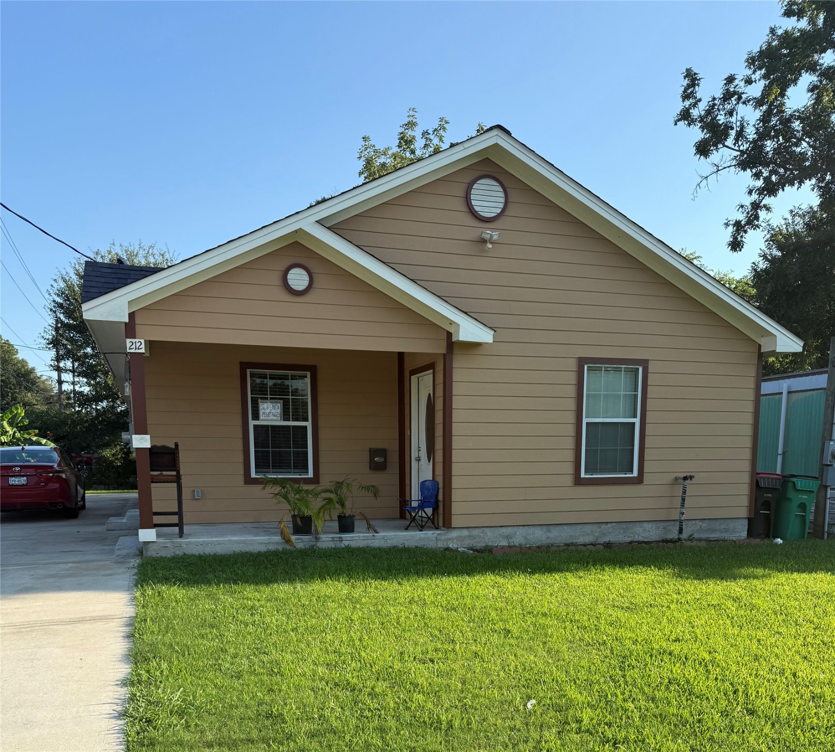 a front view of house with a garden