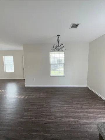 a view of room with hardwood floor and window