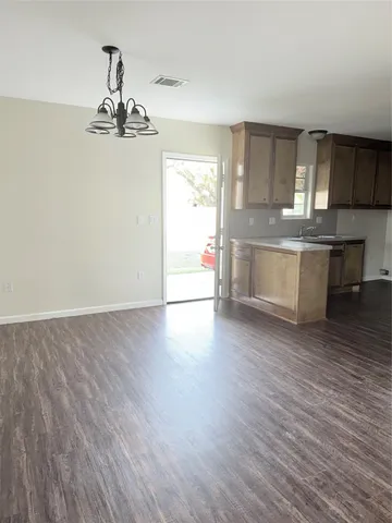 a view of a kitchen with a sink and wooden floor