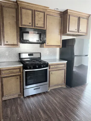 a stove top oven sitting inside of a kitchen