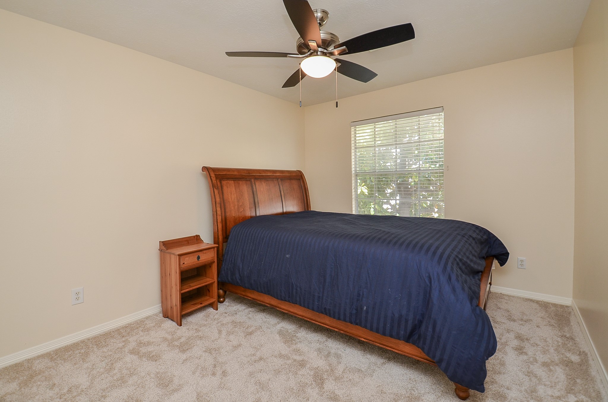4916 Inker Street Houston, TX 77007 - Photo 22 of 36 First of two secondary bedrooms, with new carpet, ceiling fan, walk in closet and views of back yard and magnolia tree.