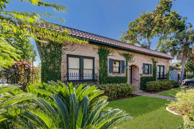 a front view of a house with a garden