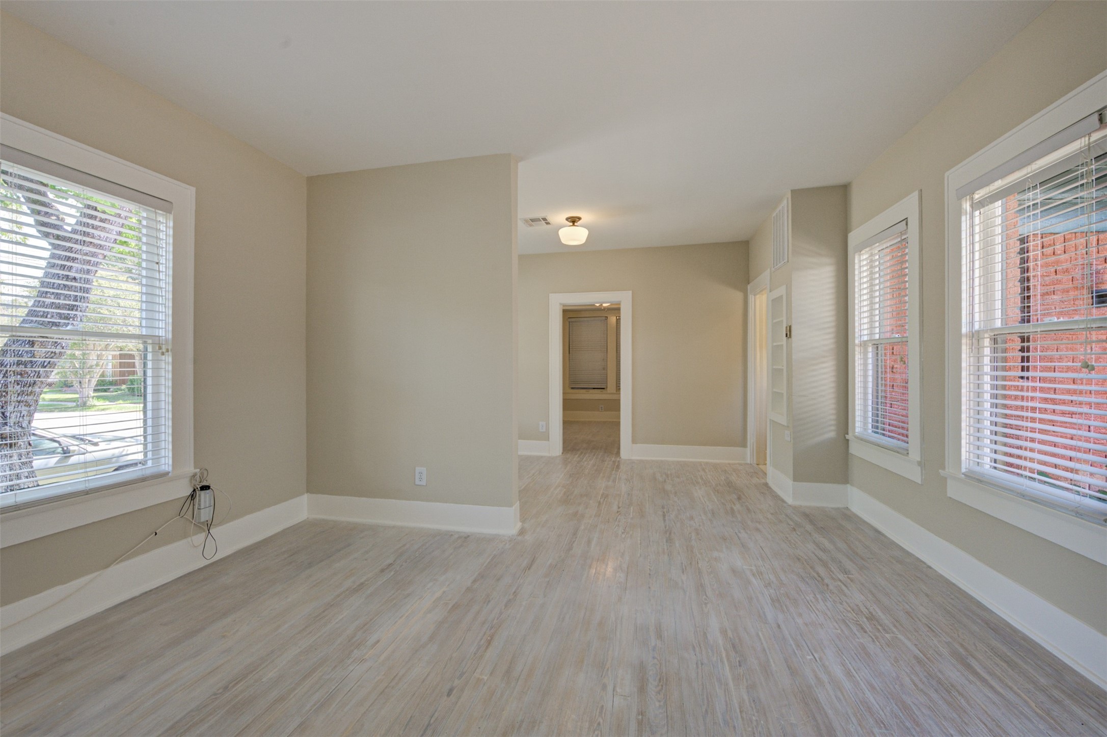 1001 Bomar Street, Unit B Houston, TX 77006 - Photo 7 of 19 a view of an empty room with wooden floor and a window