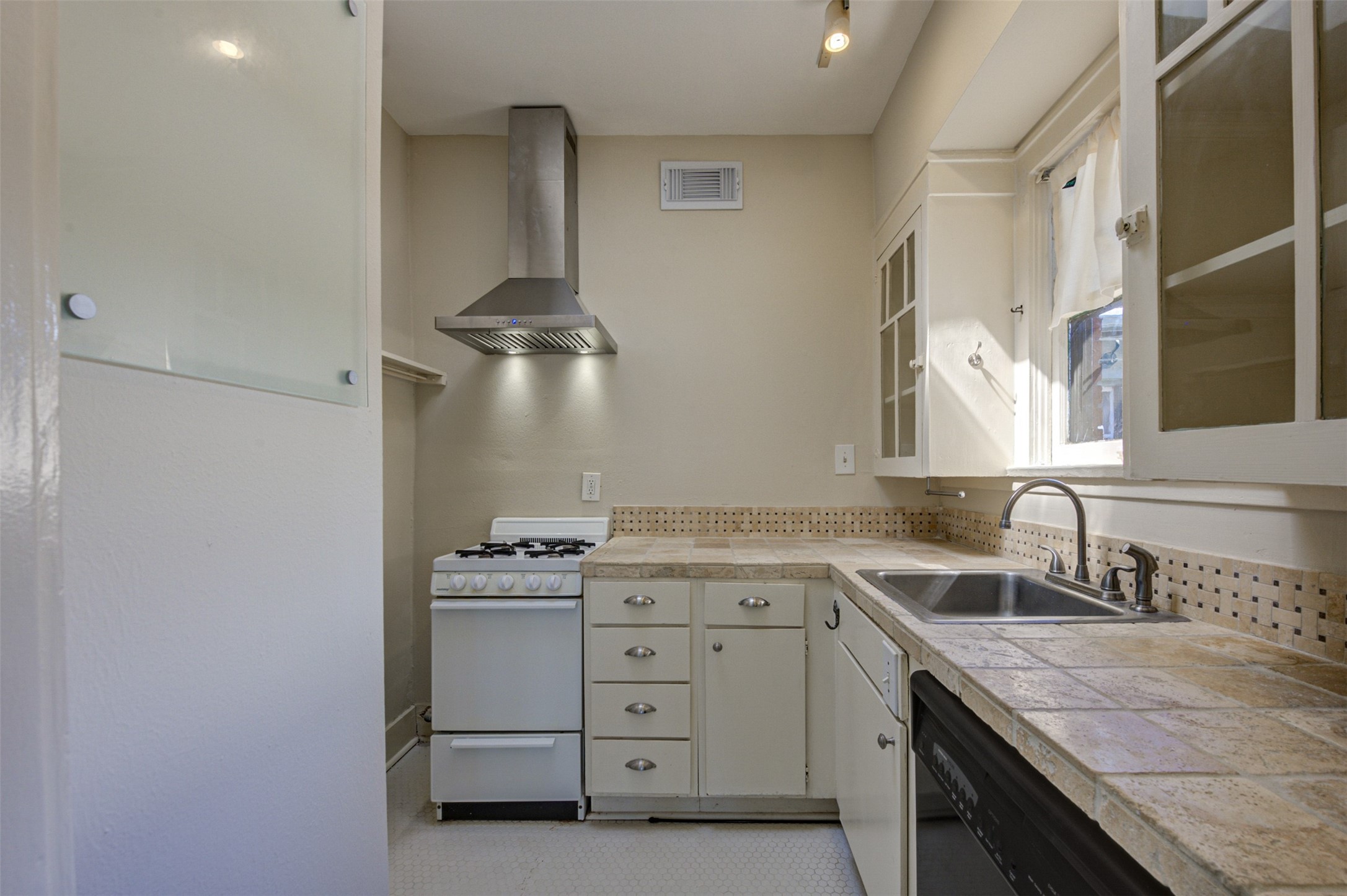 1001 Bomar Street, Unit B Houston, TX 77006 - Photo 9 of 19 a kitchen with a sink stove and cabinets