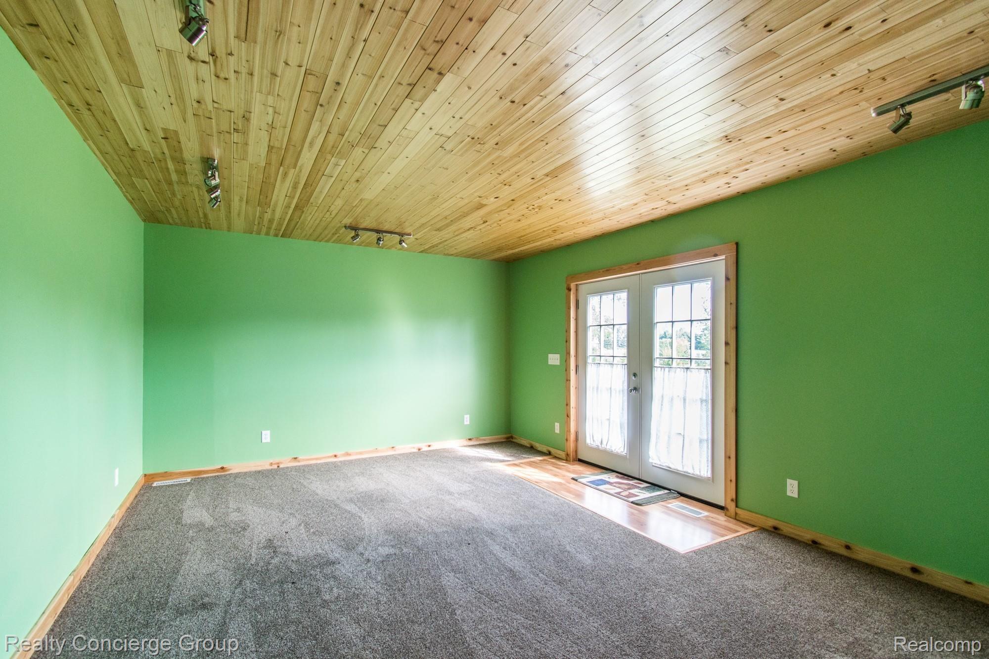 5150 North Fowlerville Road Fowlerville, MI 48836 - Photo 10 of 44 Family room with double doors to outside
