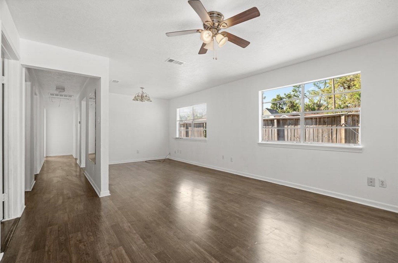 402 Paschall Street Houston, TX 77009 - Photo 4 of 11 a view of an empty room with wooden floor and a window