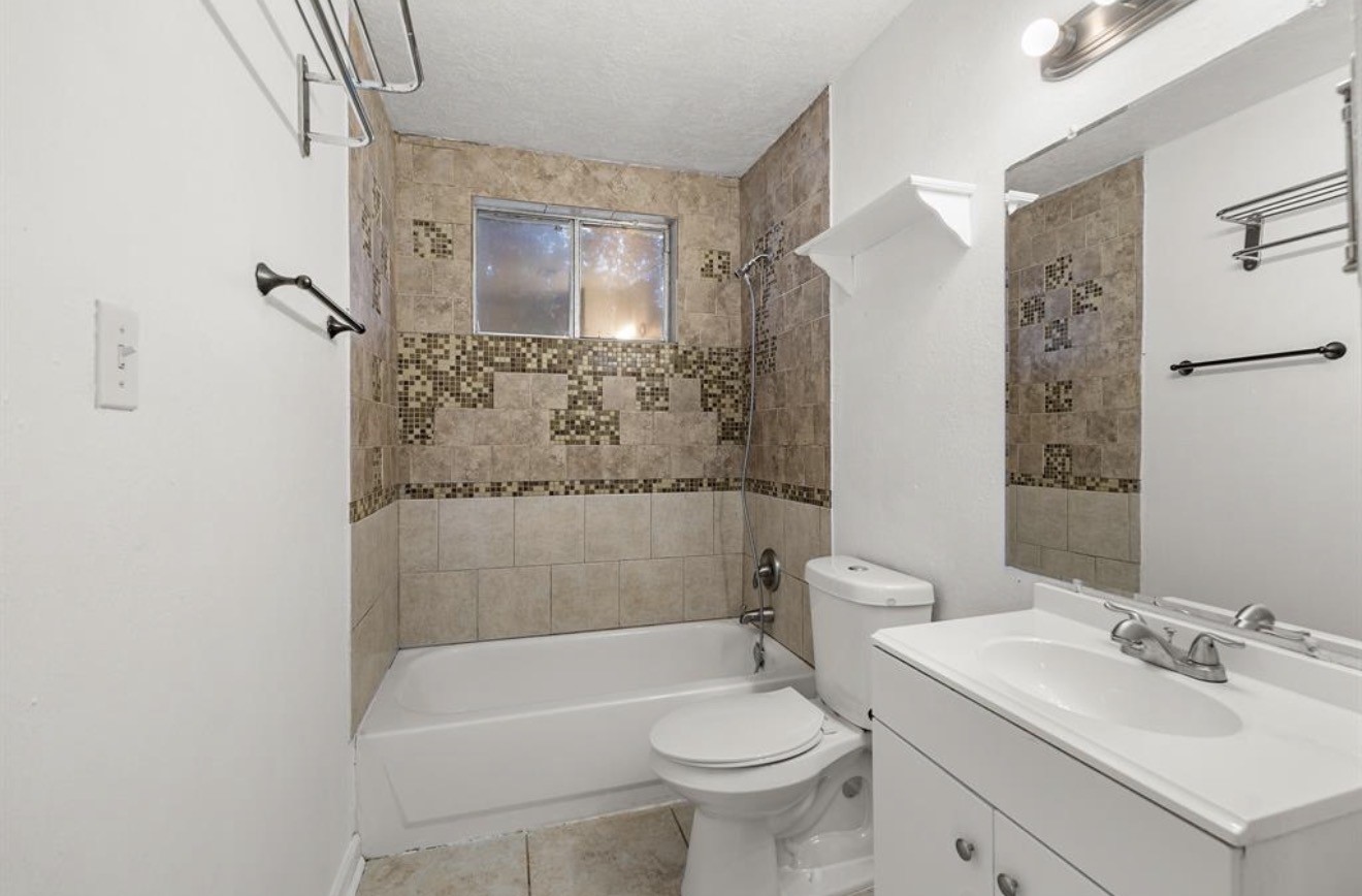 402 Paschall Street Houston, TX 77009 - Photo 6 of 11 a bathroom with a sink toilet and shower